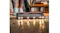 A close-up of a vacuum cleaner floor head with LED lights, cleaning scattered crumbs on the hardwood floor in a living room scene A close-up of a vacuum cleaner floor head with LED lights, cleaning scattered crumbs on the hardwood floor in a living room scene