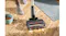 A close-up of a vacuum floor head with LED lights picking up pet kibble crumbs on a light wood floor near a mat and bowl indoors A close-up of a vacuum floor head with LED lights picking up pet kibble crumbs on a light wood floor near a mat and bowl indoors