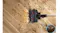 Top-down view of motorised vacuum head clearing scattered pet food crumbs across hardwood with bowl nearby and lights on Top-down view of motorised vacuum head clearing scattered pet food crumbs across hardwood with bowl nearby and lights on