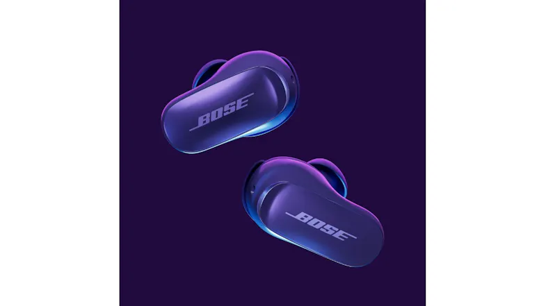 Bose wireless earbuds floating above an open charging case on a rocky surface with a warm desert setting Bose wireless earbuds floating above an open charging case on a rocky surface with a warm desert setting