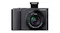 Front view of a Panasonic Lumix TZ300 camera with the pop-up flash raised, featuring a Leica lens Front view of a Panasonic Lumix TZ300 camera with the pop-up flash raised, featuring a Leica lens