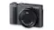 Angled front view of a Panasonic Lumix camera with the lens closed, showing top dials and the textured grip Angled front view of a Panasonic Lumix camera with the lens closed, showing top dials and the textured grip