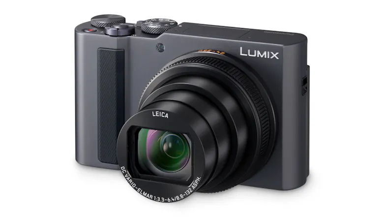 Angled view of a Lumix camera with the extended Leica zoom lens, highlighting lens details and the front grip Angled view of a Lumix camera with the extended Leica zoom lens, highlighting lens details and the front grip
