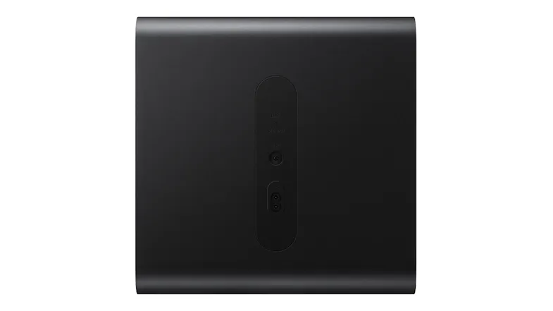 A rear view of a black wireless subwoofer displaying pairing controls and a power port A rear view of a black wireless subwoofer displaying pairing controls and a power port