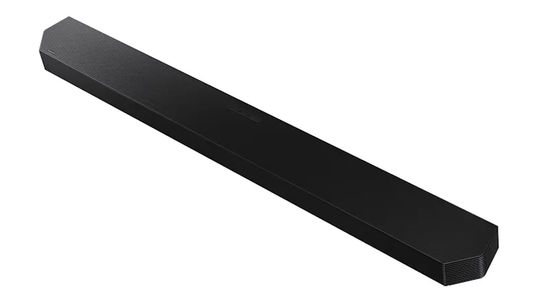 An angled top view of a slim black soundbar with a textured grille surface and integrated control buttons An angled top view of a slim black soundbar with a textured grille surface and integrated control buttons