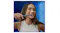 A woman smiling while brushing teeth with a black Oral-B iO electric toothbrush A woman smiling while brushing teeth with a black Oral-B iO electric toothbrush