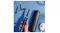 A close-up view of the Oral-B iO electric toothbrush set with multiple brush heads, travel case, and charger, shown on a blue surface A close-up view of the Oral-B iO electric toothbrush set with multiple brush heads, travel case, and charger, shown on a blue surface