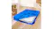 Blue Dreamz mattress storage bag partially open on a wooden floor, showing a mattress, surrounded by moving boxes and décor Blue Dreamz mattress storage bag partially open on a wooden floor, showing a mattress, surrounded by moving boxes and décor