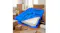 Blue Dreamz mattress storage bag, partially open on a wooden floor with boxes nearby in a bright room Blue Dreamz mattress storage bag, partially open on a wooden floor with boxes nearby in a bright room