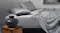 Grey modal sheet set styled on a modern bed with pillowcases and a fitted sheet with subtle texture, a minimalist nightstand with a black ceramic vase Grey modal sheet set styled on a modern bed with pillowcases and a fitted sheet with subtle texture, a minimalist nightstand with a black ceramic vase