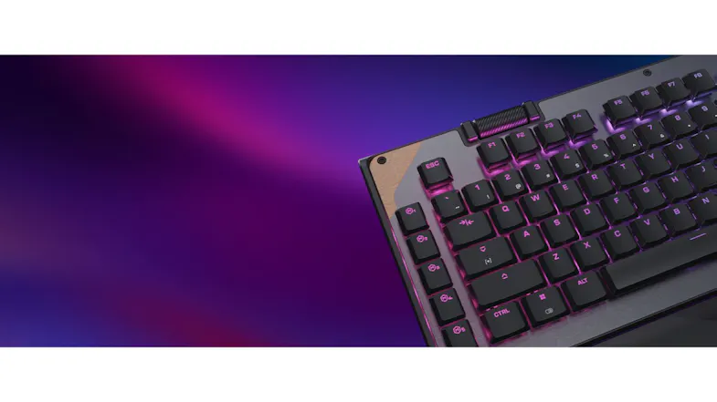 Gaming keyboard showing RGB backlit keys, media roller, and sleek metal finish Gaming keyboard showing RGB backlit keys, media roller, and sleek metal finish