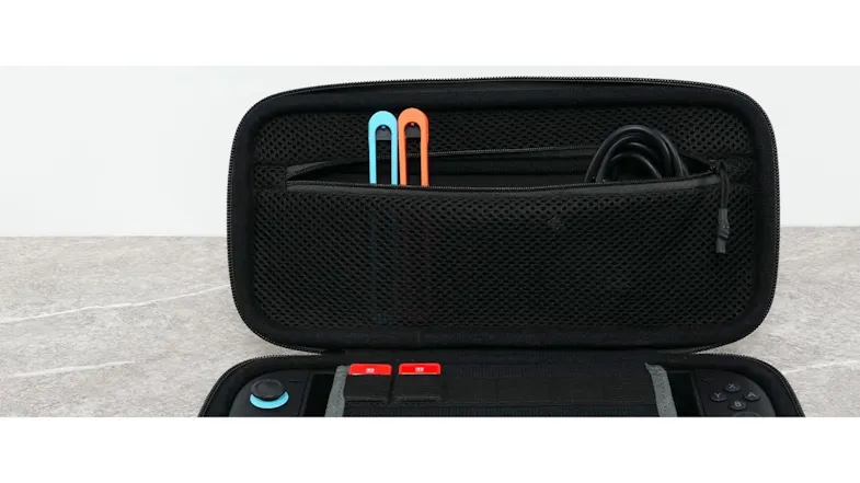 PlayTrek Switch 2 case inside view with mesh accessory pocket, charging cable, and cartridge holders PlayTrek Switch 2 case inside view with mesh accessory pocket, charging cable, and cartridge holders