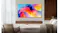 Samsung TV wall-mounted in a modern living room with a sofa, chair, and wooden panel backdrop Samsung TV wall-mounted in a modern living room with a sofa, chair, and wooden panel backdrop