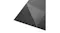 Textured black floor insulation underlay with partial peel-back showing protective film layer Textured black floor insulation underlay with partial peel-back showing protective film layer
