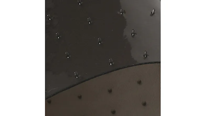 Close-up of transparent anti-slip mat edge with raised grip dots and textured waterproof surface Close-up of transparent anti-slip mat edge with raised grip dots and textured waterproof surface