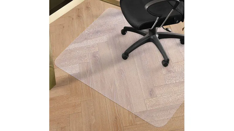 Home office setup with desk and swivel chair placed on a clear chair mat, providing floor protection and stable rolling on carpet Home office setup with desk and swivel chair placed on a clear chair mat, providing floor protection and stable rolling on carpet