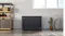 Black Haier chest freezer in a room with shelving, a plant, and a bicycle, shown against a light wall and window Black Haier chest freezer in a room with shelving, a plant, and a bicycle, shown against a light wall and window