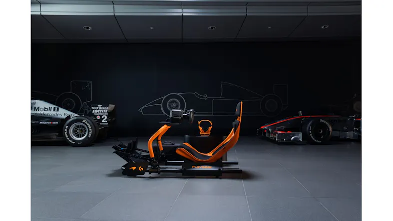 Isometric view of an orange racing seat, highlighting a headset Isometric view of an orange racing seat, highlighting a headset