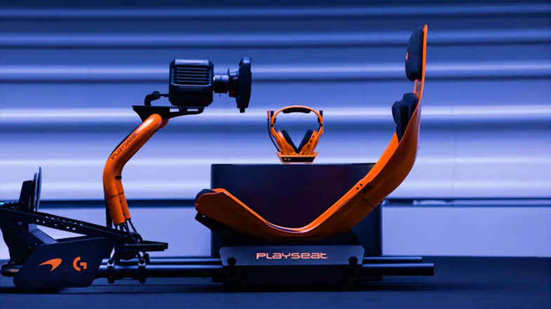 Side view of an orange racing cockpit with Playseat logo Side view of an orange racing cockpit with Playseat logo