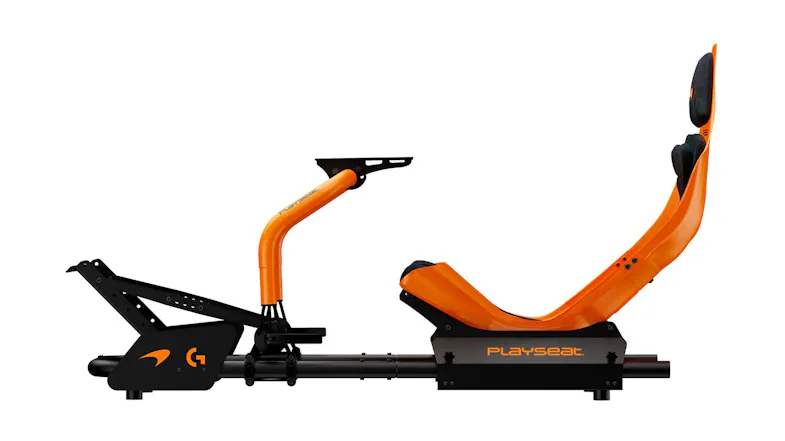 Side view of an orange racing cockpit featuring a monitor stand Side view of an orange racing cockpit featuring a monitor stand