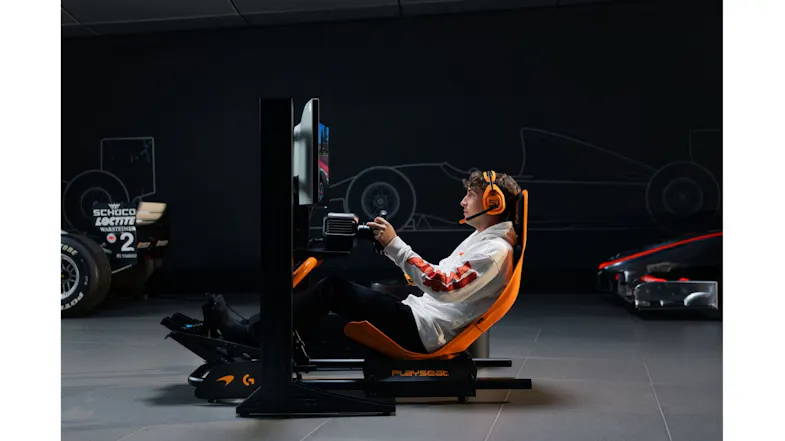 Side profile of a person in a white hoodie showing racing gear Side profile of a person in a white hoodie showing racing gear