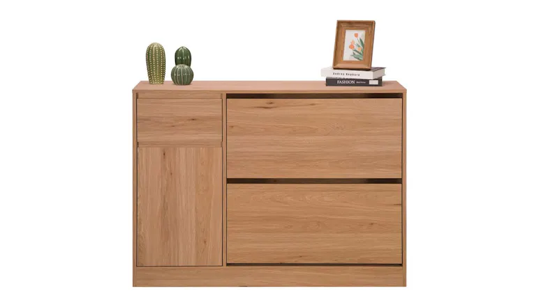 Contemporary oak cabinet with drawers and door, styled with books, plants, and a decorative frame Contemporary oak cabinet with drawers and door, styled with books, plants, and a decorative frame