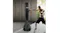 A person punching a black “CENTRA” freestanding punching bag in a modern indoor space near a window A person punching a black “CENTRA” freestanding punching bag in a modern indoor space near a window