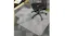 Black office chair on a clear anti-slip floor mat under the desk, protecting carpet with textured grip surface and cutout shape Black office chair on a clear anti-slip floor mat under the desk, protecting carpet with textured grip surface and cutout shape