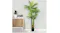 Faux tropical palm plant in a sleek indoor setting with a cabinet and potted greenery Faux tropical palm plant in a sleek indoor setting with a cabinet and potted greenery