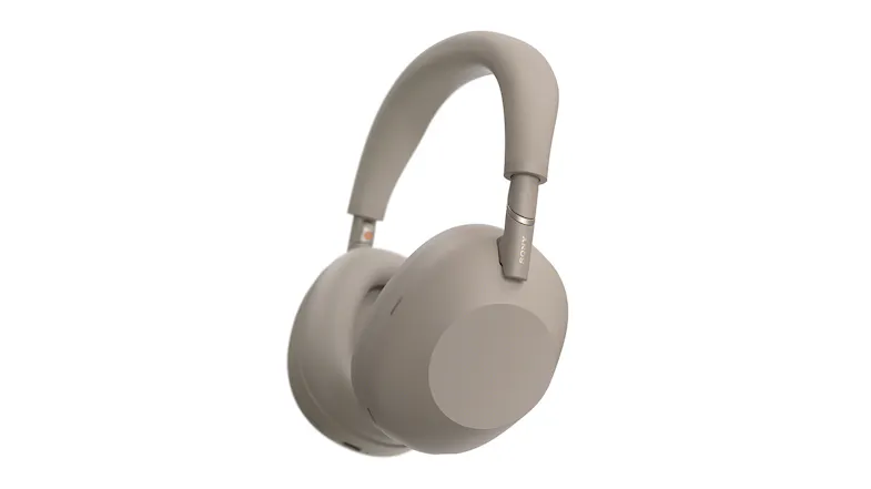 Angled side view of the WH-1000XM6 sandstone over‑ear headphones showing plush earcup and Sony logo Angled side view of the WH-1000XM6 sandstone over‑ear headphones showing plush earcup and Sony logo