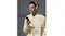 A man using a phone and the sandstone Sony headphones A man using a phone and the sandstone Sony headphones