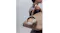 Side view of a woman showcasing Sony headphones clasped in her handbag Side view of a woman showcasing Sony headphones clasped in her handbag