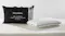 SleepMaker gel-infused cool touch mid profile pillow in white textured fabric next to its black zippered carrying bag SleepMaker gel-infused cool touch mid profile pillow in white textured fabric next to its black zippered carrying bag