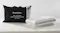 SleepMaker gel-infused cool touch high profile pillow in white textured fabric next to its black zippered carrying bag SleepMaker gel-infused cool touch high profile pillow in white textured fabric next to its black zippered carrying bag