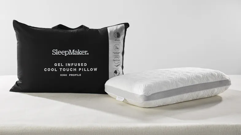 SleepMaker gel-infused cool touch high profile pillow in white textured fabric next to its black zippered carrying bag SleepMaker gel-infused cool touch high profile pillow in white textured fabric next to its black zippered carrying bag