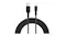 Coiled black braided Belkin USB-A to Lightning cable with both connectors visible above the loop Coiled black braided Belkin USB-A to Lightning cable with both connectors visible above the loop