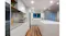 Contemporary kitchen with countertop, white cabinetry, cooktop, window, and integrated Schweigen undermount rangehood Contemporary kitchen with countertop, white cabinetry, cooktop, window, and integrated Schweigen undermount rangehood