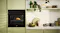 Haier 600 Series 60cm built-in steam oven in a modern green kitchen cabinet, roasting chicken with stylish shelving and decor nearby Haier 600 Series 60cm built-in steam oven in a modern green kitchen cabinet, roasting chicken with stylish shelving and decor nearby