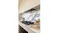 A side view of the kitchen cooktop with a marble backsplash and a concealed black glass undermount rangehood above A side view of the kitchen cooktop with a marble backsplash and a concealed black glass undermount rangehood above