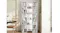 Tall white bookshelf with multiple shelves filled with books and decor, placed in a modern home interior beside the dining area Tall white bookshelf with multiple shelves filled with books and decor, placed in a modern home interior beside the dining area