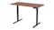 An angled view of a black height-adjustable desk frame with dual legs and a control panel An angled view of a black height-adjustable desk frame with dual legs and a control panel