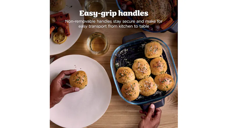Top-down view of baked rolls in a glass container with sturdy side handles Top-down view of baked rolls in a glass container with sturdy side handles