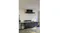 Modern outdoor kitchen with black range hood above grill, dark cabinets, sink, and beverage fridge against a light wall Modern outdoor kitchen with black range hood above grill, dark cabinets, sink, and beverage fridge against a light wall