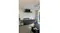 Sleek outdoor kitchen setup with rangehood, grill, sink, cabinets, and beverage cooler Sleek outdoor kitchen setup with rangehood, grill, sink, cabinets, and beverage cooler