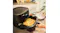 Braun MultiFry 5 air fryer on a kitchen countertop with the drawer pulled out, filled with golden fries Braun MultiFry 5 air fryer on a kitchen countertop with the drawer pulled out, filled with golden fries