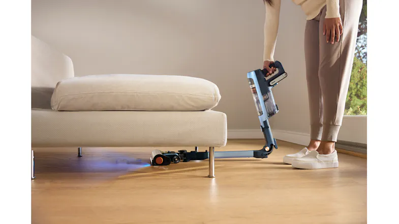 Vacuum laid almost flat to clean under a sofa, with the floor head reaching beneath the low clearance Vacuum laid almost flat to clean under a sofa, with the floor head reaching beneath the low clearance