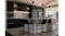 Modern kitchen with undermount rangehood with dark cabinetry, countertop, black bar stools, pendant lights and built-in oven Modern kitchen with undermount rangehood with dark cabinetry, countertop, black bar stools, pendant lights and built-in oven
