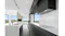 Kitchen interior with white marble island, black cabinets, and a built-in rangehood overlooking scenic countryside Kitchen interior with white marble island, black cabinets, and a built-in rangehood overlooking scenic countryside
