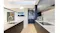 Modern kitchen with an island sink, marble countertops, dark cabinets, and a built-in rangehood overhead Modern kitchen with an island sink, marble countertops, dark cabinets, and a built-in rangehood overhead