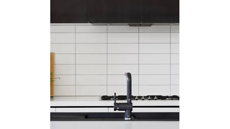 Close kitchen view showing a stovetop, with the stainless steel undermount rangehood subtly visible Close kitchen view showing a stovetop, with the stainless steel undermount rangehood subtly visible